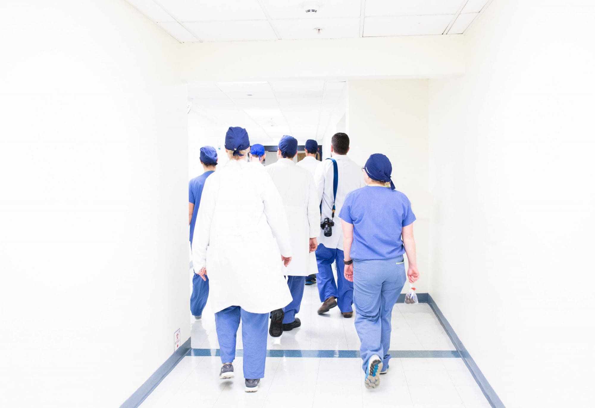 line of doctors walking in a corridor