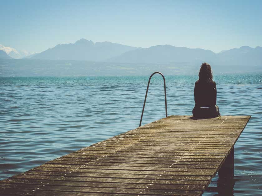 girl sitting on edge of jetty